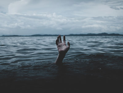 Hand coming out of flood water