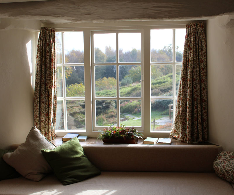 Window with curtains and cushions