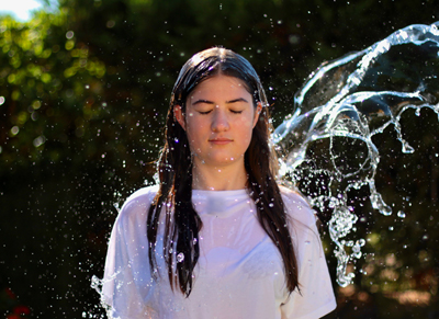 Woman being splashed by water