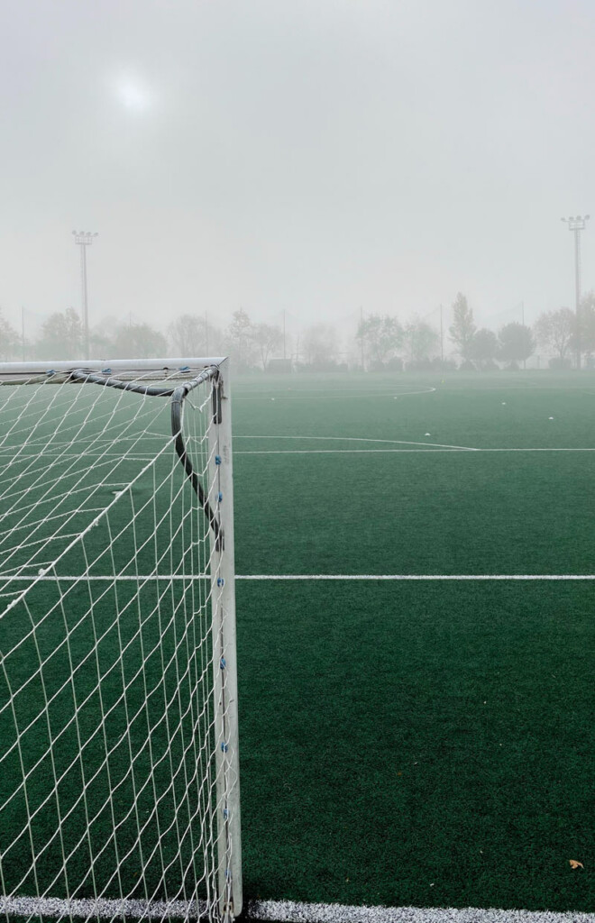 Empty football pitch in rain