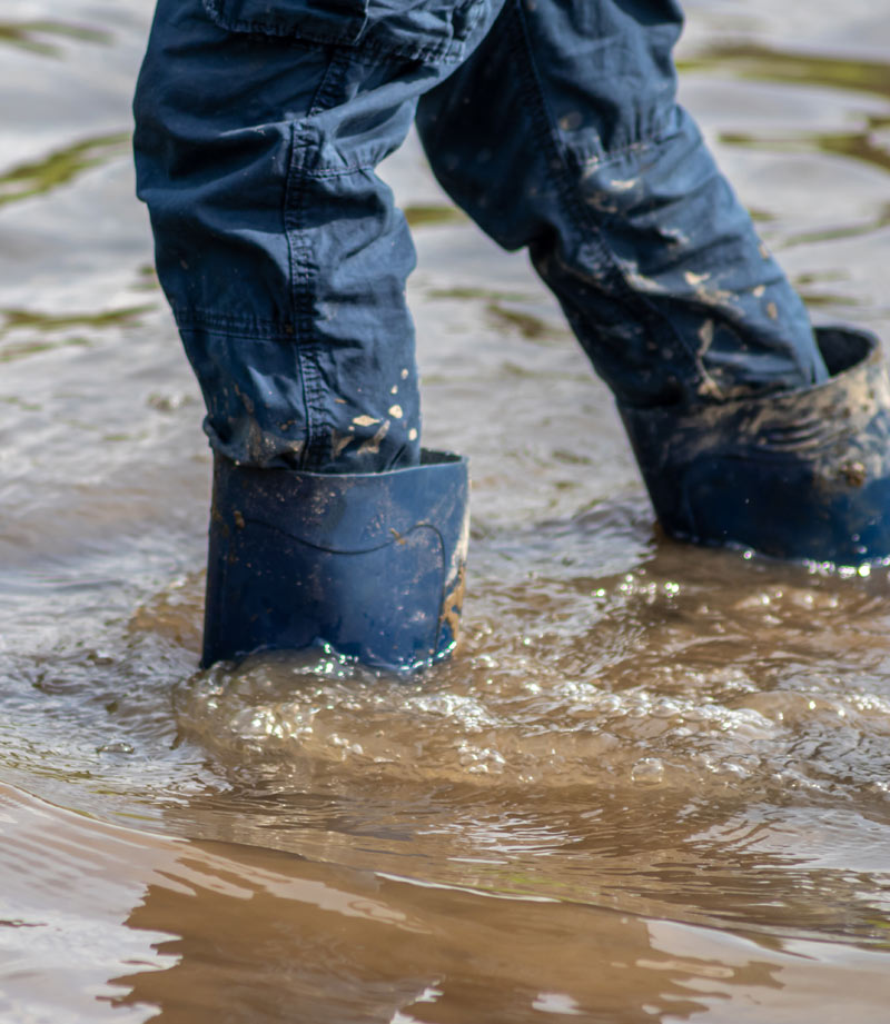 Person wading through flood water