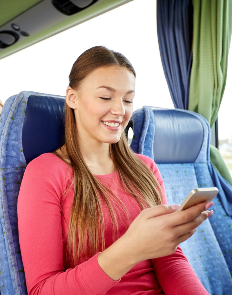 Woman using wifi on a bus