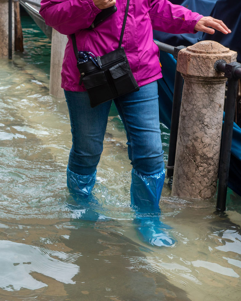 Person wading through flood water